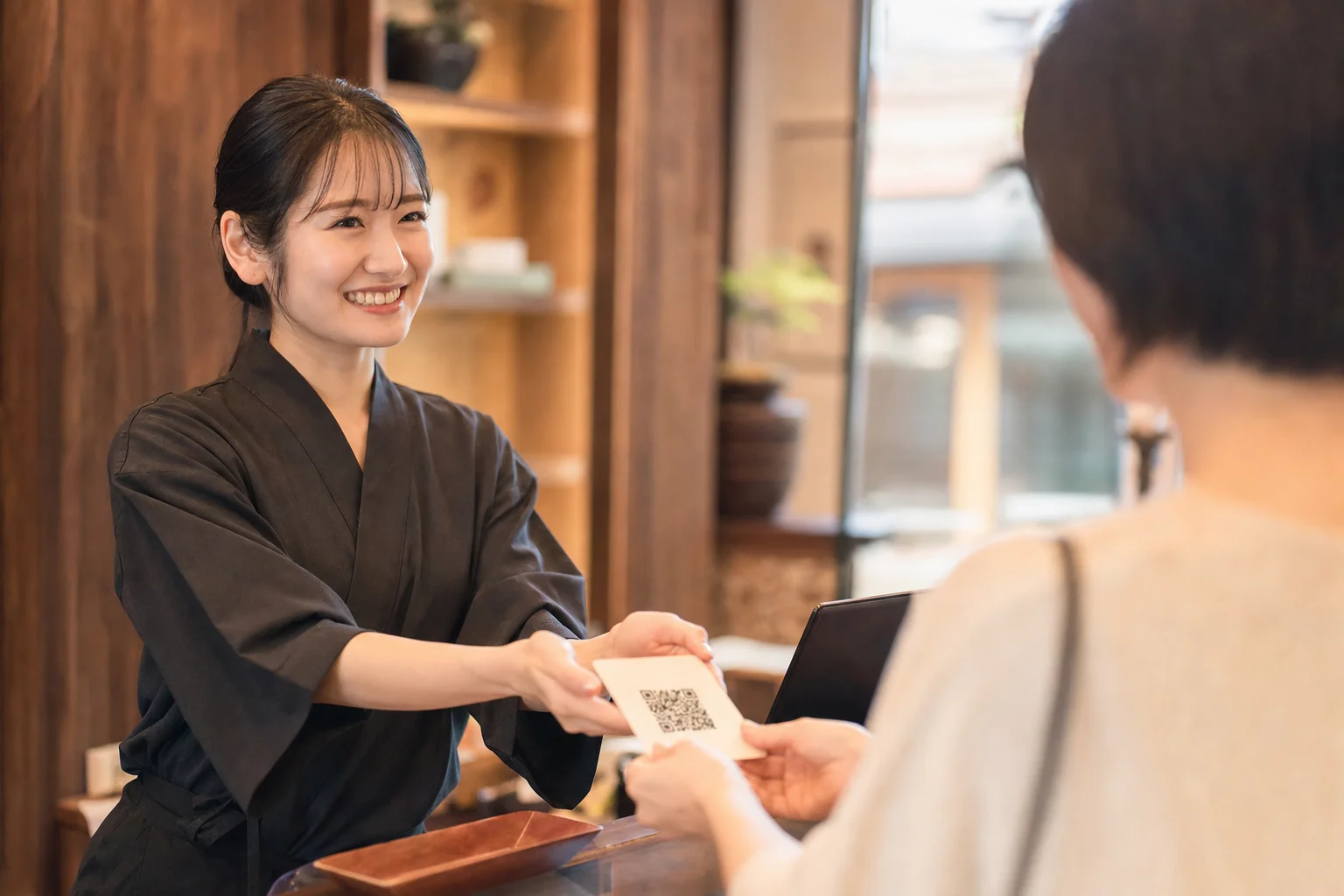 会計時にお客さまへ笑顔で口コミ投稿をお願いするスタッフ